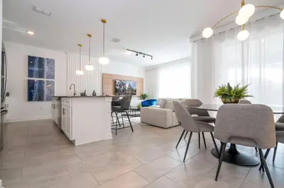 a kitchen and living room with a table and chairs at Brand new fantastic home at Storey lake (SL4447) in Kissimmee