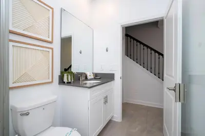 a bathroom with a toilet and a sink at Brand new fantastic home at Storey lake (SL4447) in Kissimmee