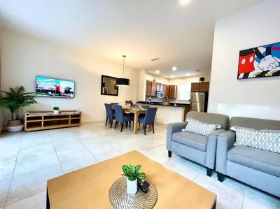 a living room with a couch and a table at AMAZING vacation house .Mins to Disney Regal oasks in Orlando