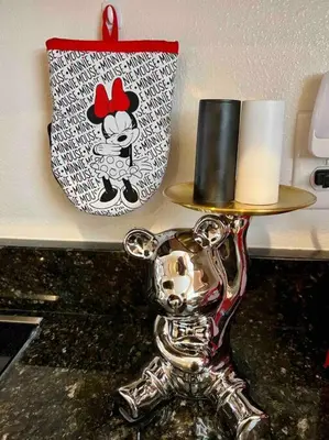a table with a candle and a holder with a mickeyactedactediety at AMAZING vacation house .Mins to Disney Regal oasks in Orlando