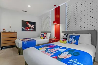 a bedroom with two beds with mickey mouse on them at Find your Cozy home 8 minutes near Disney and Universal in Orlando