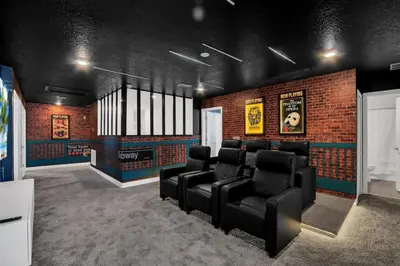 a waiting room with black chairs and a brick wall at Perfect Disney Vacation Home in Kissimmee