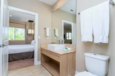 a bathroom with a sink and a toilet and a bed at Modern and Luxury 4 suites close to Disney 7544 in Orlando