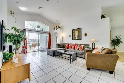 a living room with a couch and a table at 4 Mi to Disney Family Getaway with Game Room! in Kissimmee