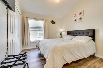 a bedroom with a large bed and a window at 4 Mi to Disney Family Getaway with Game Room! in Kissimmee