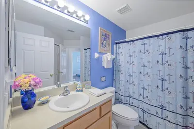 a bathroom with a sink and a toilet and a shower at Cozy Private Home at Terra Verde Resort, South Facing Pool Spa, Near Disney, SeaWorld in Kissimmee