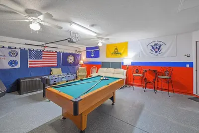 a pool table in a room with an american flag at Cozy Private Home at Terra Verde Resort, South Facing Pool Spa, Near Disney, SeaWorld in Kissimmee