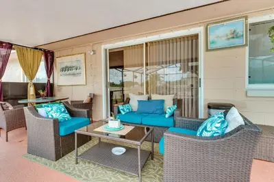 a patio with blue couches and a table at 25 Mi to Disney Home with Shared Pool in Orlando in Orlando