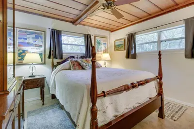 a bedroom with a bed and two windows at Near Kayak Launch Riverfront Home in Sanford! in Sanford