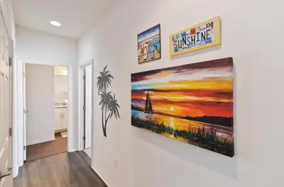 a hallway with a painting on a wall at 43 Townhouse Near Disney!! in Kissimmee