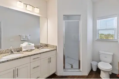 a bathroom with a toilet and a sink and a shower at 43 Townhouse Near Disney!! in Kissimmee
