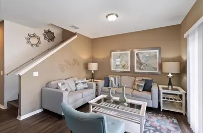 a living room with a couch and a table at 43 Townhouse Near Disney!! in Kissimmee