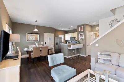 a living room and dining room with a couch and a table at 43 Townhouse Near Disney!! in Kissimmee
