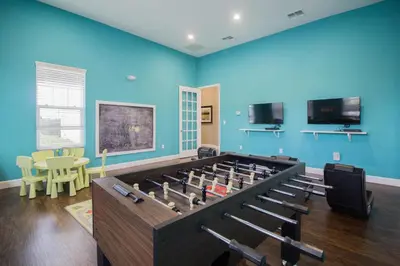 a large room with a large table full of books at 43 Townhouse Near Disney!! in Kissimmee