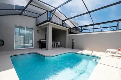 a swimming pool in a house with a glass ceiling at Marvelous 4Bd with Pool at Storey Lake Resort 2601 in Kissimmee