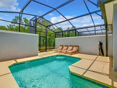 a swimming pool in a house with a glass roof at 4BR Townhouse with Private Pool near Disney in Kissimmee