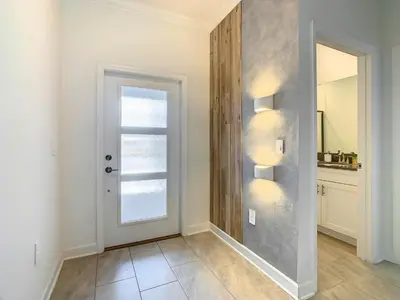 an empty hallway with a door and a window at 4BR Townhouse with Private Pool near Disney in Kissimmee
