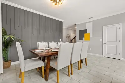 a dining room with a wooden table and chairs at Upstay Modern 5BR Resort Home w Pool & Hot Tub in Kissimmee