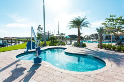 a pool at a resort with a slide at Upstay Modern 5BR Resort Home w Pool & Hot Tub in Kissimmee
