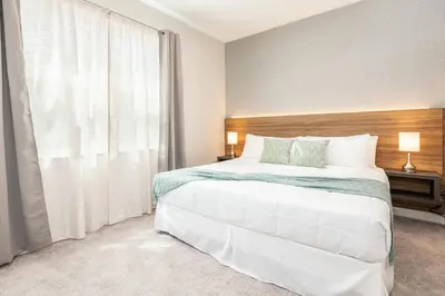a bedroom with a large bed and a large window at 7988 Magical 5BD Home Perfect Disney Retreat in Kissimmee