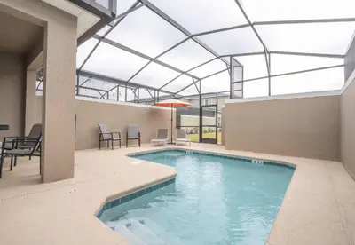 an indoor swimming pool with a glass ceiling at 2941 Modern Four Bedroom Locate at Storey Lake in Kissimmee