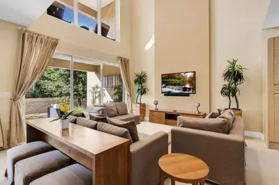 a living room with couches and a table at Luxury Townhouse located NEXT to DISNEY ORLANDO in Orlando