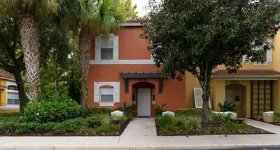 a orange and white house with trees and a sidewalk at bsv_villa8445 in Kissimmee