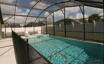 a swimming pool in a building with at Emma Castle - private fenced home 3 miles to Disney in Kissimmee