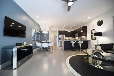 a living room with a couch and a dining room at Beautiful 3-Bed Villa 10 Minutes From Disney - Serenity Resort townhouse in Orlando