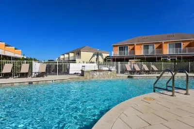 a swimming pool with chairs in a resort at 3 Bedroom Private Pool With Spa Near Disey villa in Orlando