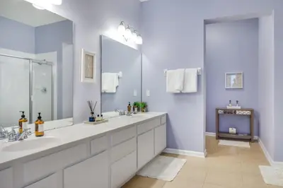 a bathroom with two sinks and a large mirror at Penthouse Utopia condo in Orlando