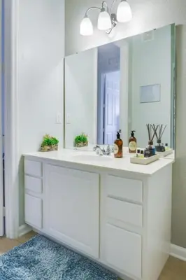 a bathroom with a white sink and a mirror at Penthouse Utopia condo in Orlando