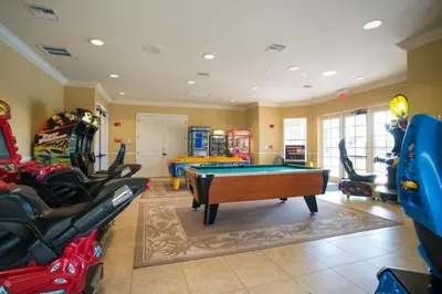 a billiard room with a pool table and some chairs at Penthouse Utopia condo in Orlando