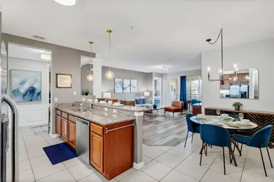 a kitchen and living room with a table and chairs at Vista Cay Magic condo in Orlando