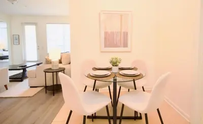 a dining room with a table and white chairs at NEW! Vista Cay Luxury Mirage condo in Orlando