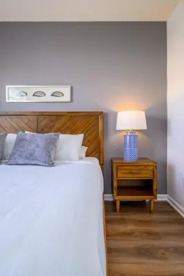 a bedroom with a bed and a nightstand with a lamp at Vista Cay Electra condo in Orlando