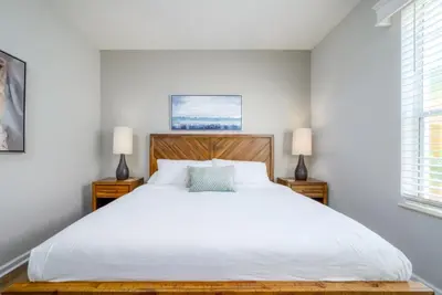a bedroom with a large white bed and two lamps at Vista Cay Electra condo in Orlando