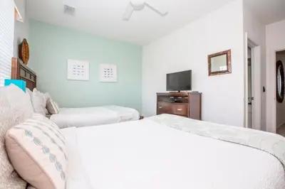 a bedroom with two beds and a tv at Vista Cay Casa Bonita townhouse in Orlando