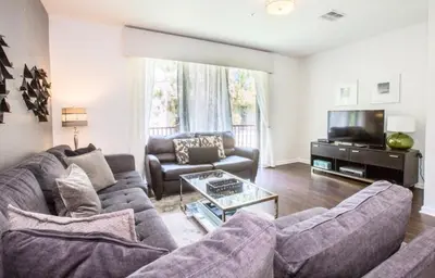 a living room with a couch and a tv at Vista Cay Casa Bonita townhouse in Orlando