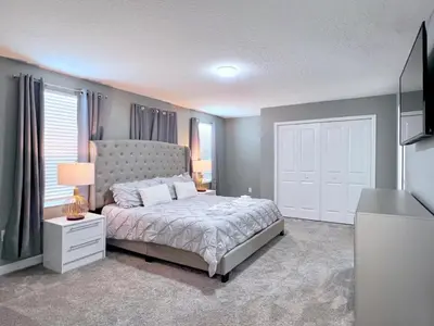 a bedroom with a bed and a television in it at 8 Bed Storey Lake Resort- Huge Bedroom for Kids home in Kissimmee