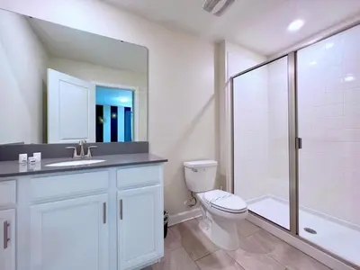 a bathroom with a toilet and a sink and a shower at 8 Bed Storey Lake Resort- Huge Bedroom for Kids home in Kissimmee