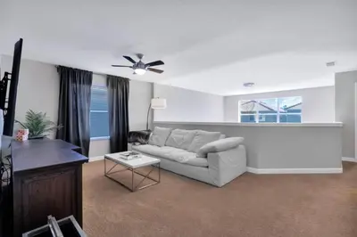 a living room with a couch and a ceiling fan at Bismarck Palms home in Kissimmee