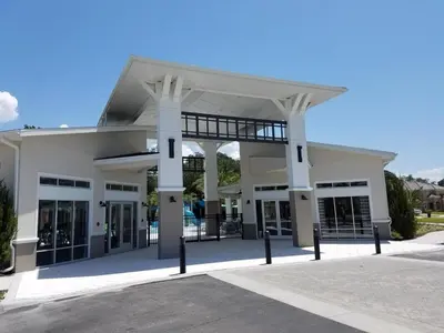 a large white building with columns and windows at Cozy 4 Bed 3 Bath Private Pool Home with Game Room home in Kissimmee