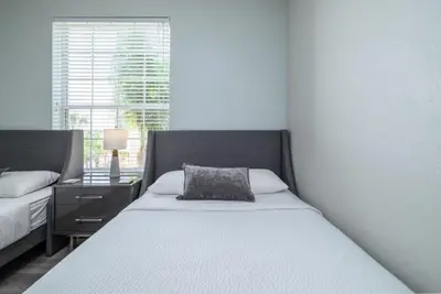 a bedroom with a bed with a pillow on it at Vista Cay Lakeview Elysium condo in Orlando