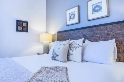a bedroom with a large bed with white pillows at LakeView Penthouse Elegance condo in Orlando