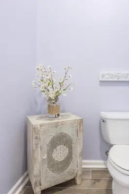 a bathroom with a toilet and flowers on a table at LakeView Penthouse Elegance condo in Orlando