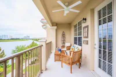 a porch with a ceiling fan and a view of the water at LakeView Penthouse Elegance condo in Orlando