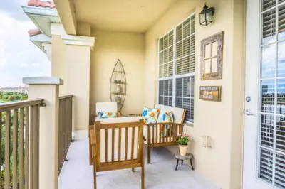 a porch with two chairs and a window at LakeView Penthouse Elegance condo in Orlando