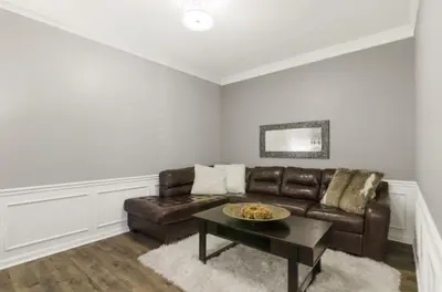 a living room with a leather couch and a table at Vista Cay Luxury Secret condo in Orlando