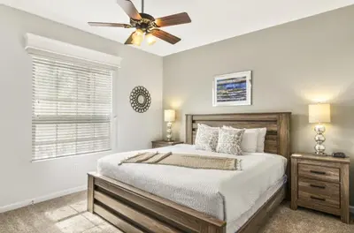a bedroom with a bed and a ceiling fan at Vista Cay Luxury Secret condo in Orlando